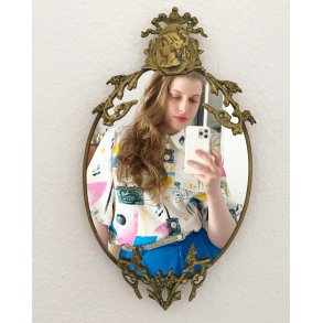 Brass mirror, relief at the top