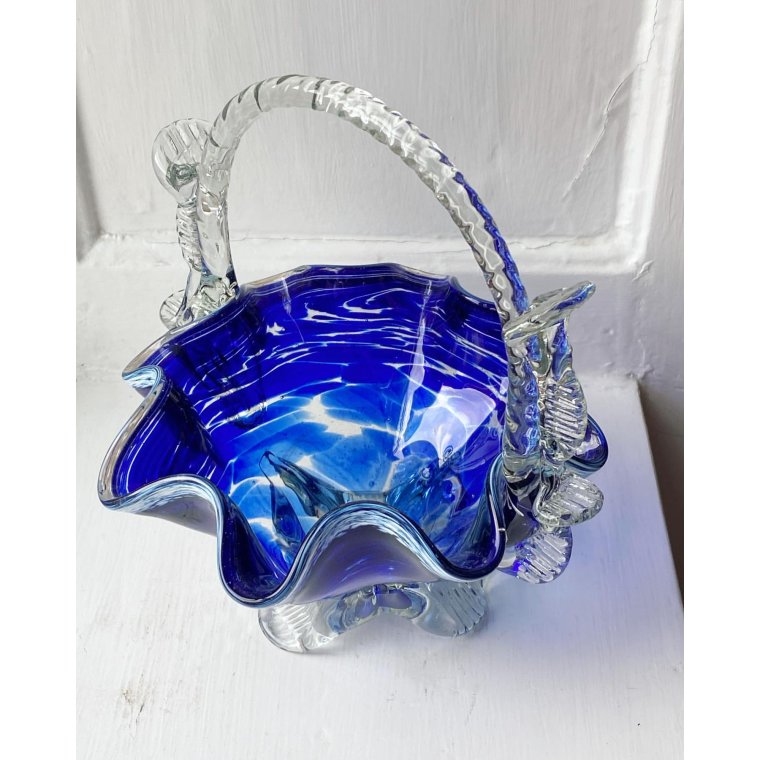 Blue glass basket with clear handle and white edge