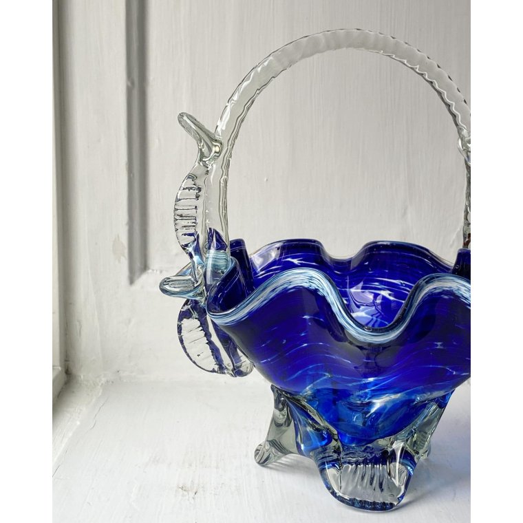 Blue glass basket with clear handle and white edge