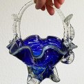 Blue glass basket with clear handle and white edge