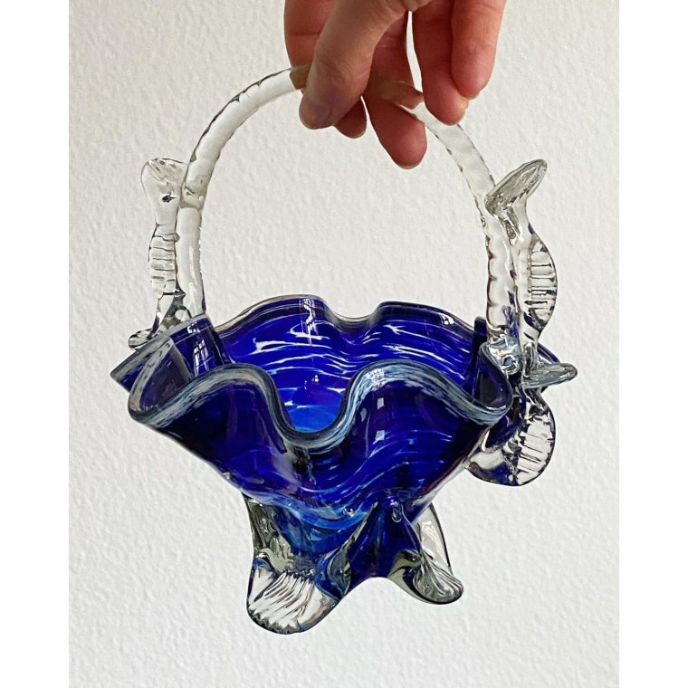 Blue glass basket with clear handle and white edge
