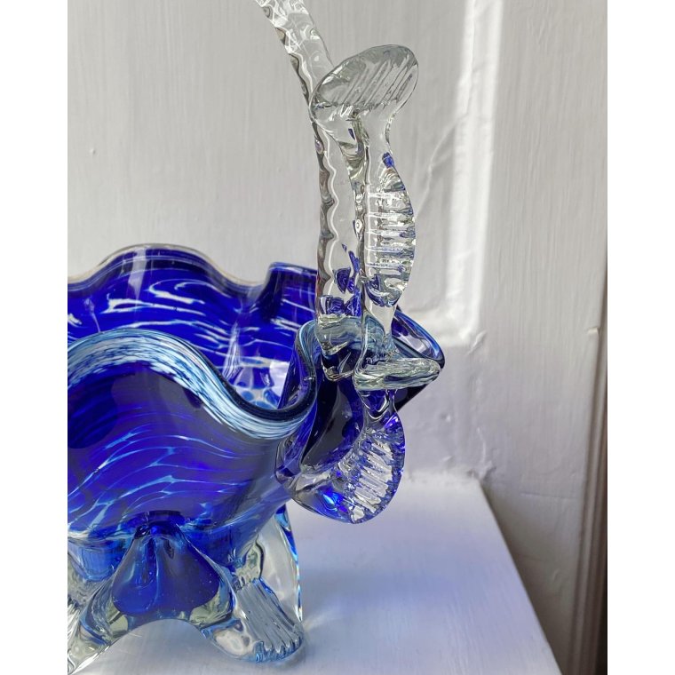 Blue glass basket with clear handle and white edge