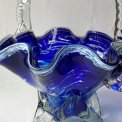 Blue glass basket with clear handle and white edge