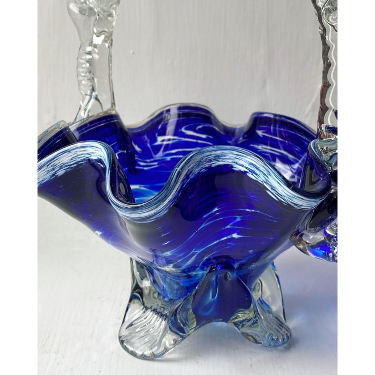 Blue glass basket with clear handle and white edge