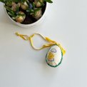 Easter egg with embroidered chicken and ribbon