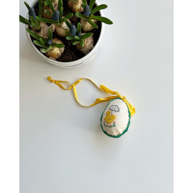 Easter egg with embroidered chicken and ribbon
