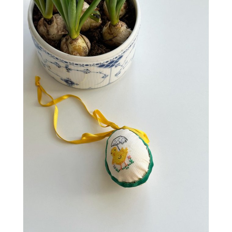 Easter egg with embroidered chicken and ribbon